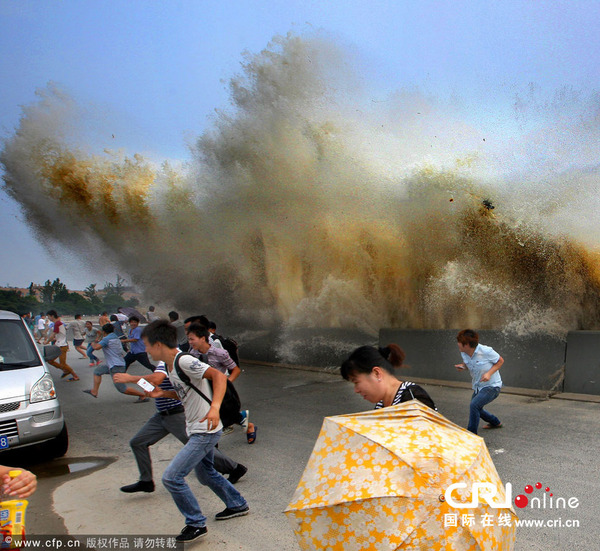 2014年8月29日，杭州。 钱江潮排山倒海般袭来，吓得观潮客落荒而逃。图片来源：CFP