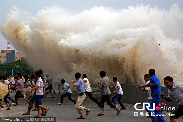2014年08月29日，浙江省杭州市，钱塘江下沙段，开心躲避潮水的游客。图片来源：CFP