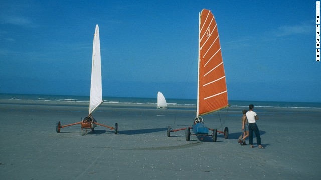 Landsailing isn\'t just restricted to deserts. Here, enthusiasts test out their designs on a European beach in the 1970s. 