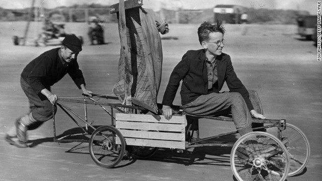 Here British youngsters in the 1950s go for a spin in their makeshift vehicle -- an old pram with a raincoat for a sail.